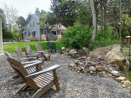 Orleans Cape Cod vacation rental - Rustic stone firepit in camp-like setting by the covered porch.
