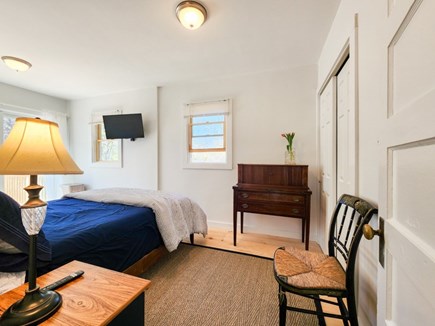 Harwich Cape Cod vacation rental - Main bedroom with full bed, tv, and slider access to deck.