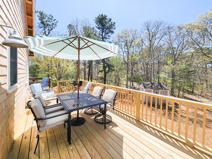 Harwich Cape Cod vacation rental - Back deck with seating and view of wooded acre.