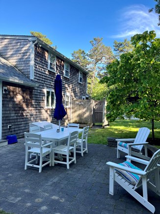 Harwich Cape Cod vacation rental - Fenced in yard with grill and patio set