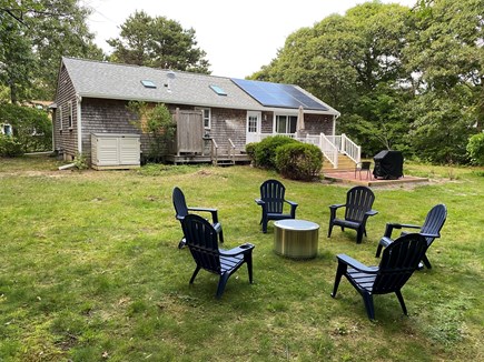 Eastham Cape Cod vacation rental - Rear yard, firepit, patio/grill, deck w/ picnic table/umbrella