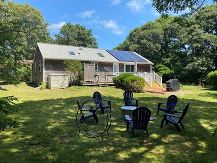 Eastham Cape Cod vacation rental - Backyard with firepit, outdoor shower, deck, picnic table, bbq
