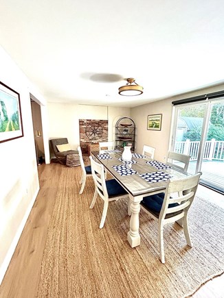 Eastham Cape Cod vacation rental - Full dining room with farm table and sliders to back deck.