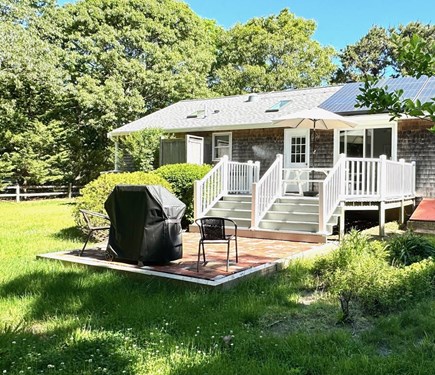 Eastham Cape Cod vacation rental - Back deck  leads to brick patio with Weber grill.<br/>