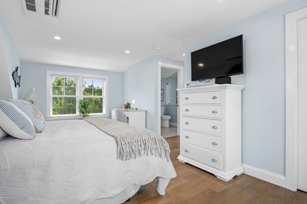 Chatham Cape Cod vacation rental - Primary bedroom view of flat screen TV and ensuite bathroom