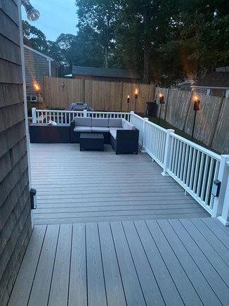 South Dennis Cape Cod vacation rental - Spacious deck with soft seating-tiki torches-sunrise and sunset.