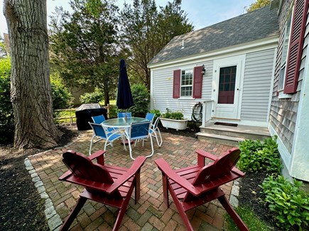 Wellfleet Cape Cod vacation rental - Back patio kitchen with table, 6 chairs, umbrella, propane grill