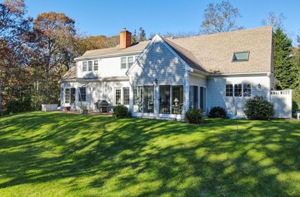 Brewster Cape Cod vacation rental - Note the patio and screened porch, each with a water view.
Also note the enclosed outdoor shower at far right.