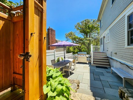 New Seabury, Popponesset  Cape Cod vacation rental - Side yard with outdoor shower, grill, seating, and side entrance.