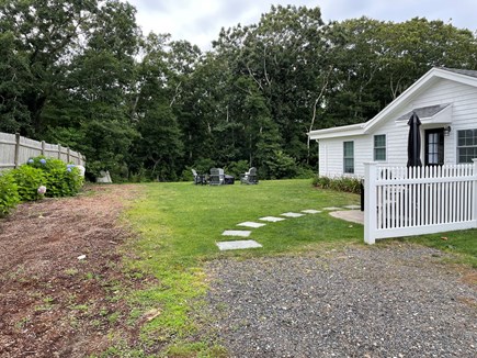 West Yarmouth Cape Cod vacation rental - Private yard with Adirondack chairs, fire pit, and parking for 4