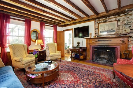 Barnstable Cape Cod vacation rental - This welcoming parlor has a large, wood-burning fireplace.