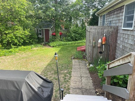 Harwich Cape Cod vacation rental - Outdoor shower and Weber gas grill shed for bike storage.