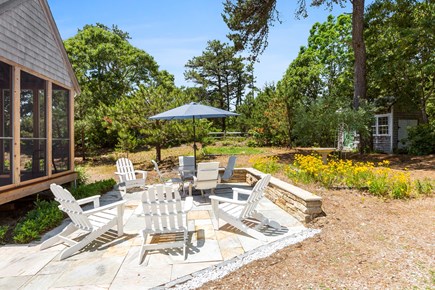 Eastham Cape Cod vacation rental - Adirondack chairs and an outdoor dining table on the patio