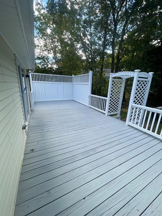 Monument Beach - Bourne  Cape Cod vacation rental - Large back deck with grill, fire pit, dining table and chairs.