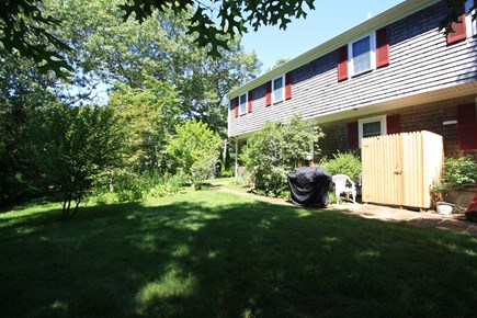 South Dennis Cape Cod vacation rental - Shaded back yard with gas grill and outdoor shower