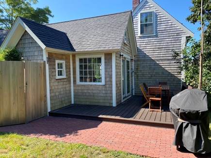 North Truro Cape Cod vacation rental - Deck off kitchen sliding doors, patio grill area, outdoor shower.
