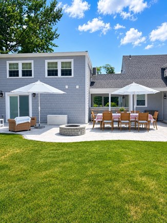 Harwich Port Cape Cod vacation rental - Spacious patio with firepit, plenty of seating, and outdoor bar.