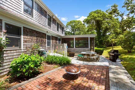 Chatham Cape Cod vacation rental - Shaded back patio with propane grill, outdoor shower and table