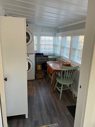 Dennis Port Cape Cod vacation rental - Dining room area with tall white pantry and W/D.