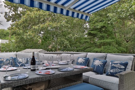 Dennis Port Cape Cod vacation rental - patio w/ retractable awning, 6 burner grill and lots of seating!