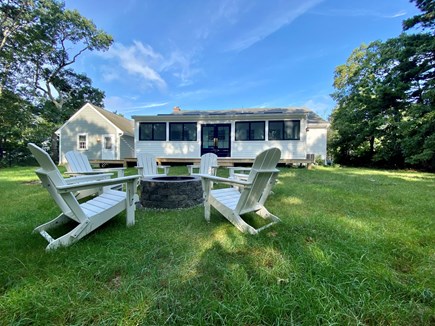 Dennis Cape Cod vacation rental - New stone firepit and Adirondack chairs in fenced in back yard
