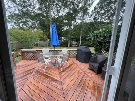 East Falmouth Cape Cod vacation rental - Back porch w/ grill plenty of chairs and hooks for towels