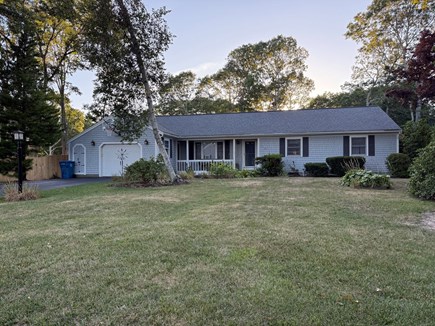 East Falmouth Cape Cod vacation rental - Street view of large front yard, driveway for 3 cars, and garage