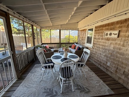 Dennis Port Cape Cod vacation rental - Screened-in porch with dining and lounging areas