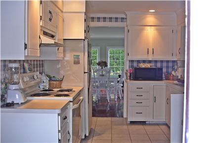 Sagamore Beach, Bourne Cape Cod vacation rental - View from bright, white kitchen looking into dining room.