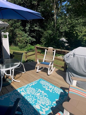 Brewster Cape Cod vacation rental - Deck off of kitchen area with gas grill, table, and chairs.