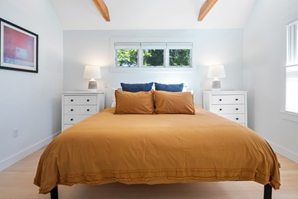 Eastham Cape Cod vacation rental - Primary bedroom w/ King bed & cathedral ceilings w/ built in fan