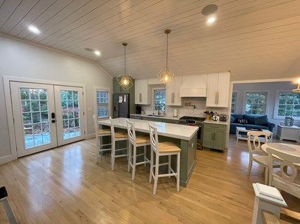 Yarmouth Port Cape Cod vacation rental - New kitchen with Cafe appliances, ice maker, and dining table.