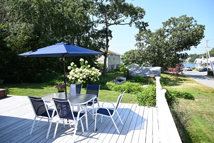 Onset MA vacation rental - Deck with dining area, seating and grill with water view