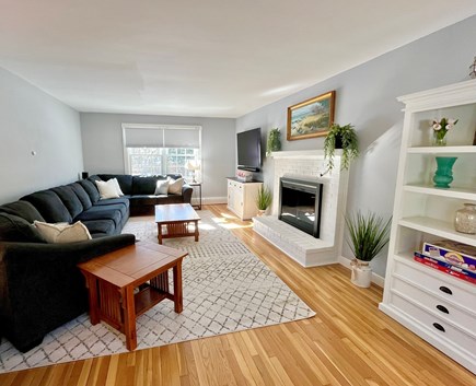 Marstons Mills Cape Cod vacation rental - Living room with large sectional, 65” smart tv, gas fire place.