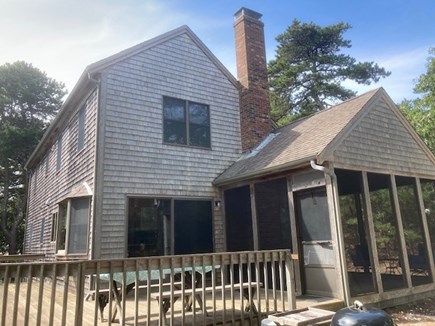 Wellfleet Cape Cod vacation rental - Side of house, showing deck and screened in porch.