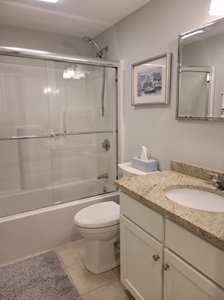 Harwichport Cape Cod vacation rental - Full bathroom with tub shower combo. New glass shower door 2023