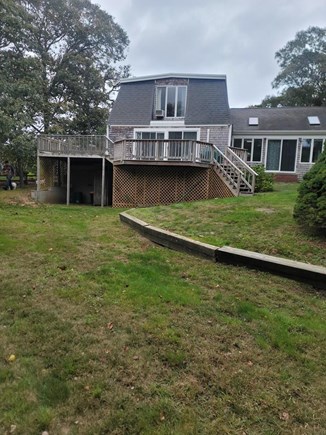 S Harwich Skinequit Pond area  Cape Cod vacation rental - Back of house with large private yard, deck and outdoor shower