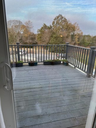 East Dennis Cape Cod vacation rental - Winter view of deck beyond sliders. Visualize table/chairs, grill