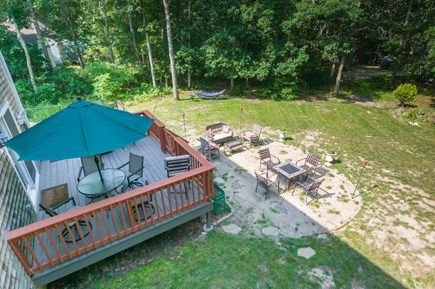 Mashpee Cape Cod vacation rental - Back yard with deck and seating.