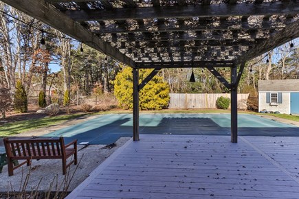 Eastham Cape Cod vacation rental - New deck, pergola and views of pool and gorgeous fenced yard.