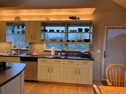 Truro, Cobb Farm Cape Cod vacation rental - Kitchen with door to deck, with lounge chairs, grill, table etc