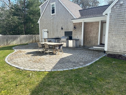 Osterville Cape Cod vacation rental - Outdoor kitchen with gas grille. bar and dining table.