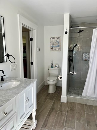 Centerville Cape Cod vacation rental - Master bathroom, two sinks, walk in shower, and washer/dryer