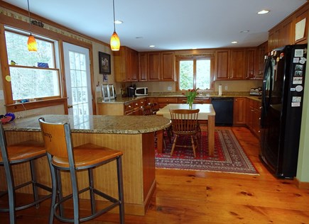 Centerville Cape Cod vacation rental - Kitchen with seating area, breakfast bar, door to deck w/ grill