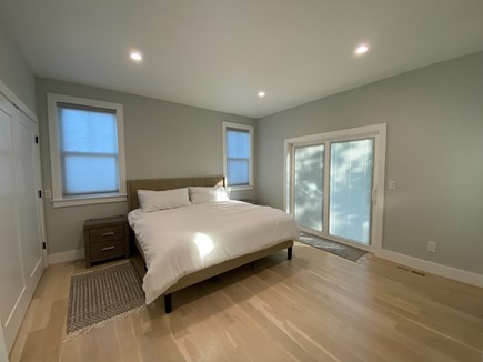North Falmouth  Cape Cod vacation rental - 1st floor bedroom with king bed and a slider to a small patio.