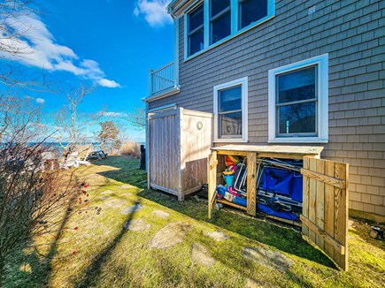 Brewster Cape Cod vacation rental - Side yard with outdoor shower, beach gear, firepit, water views