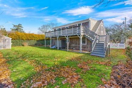 West Yarmouth Cape Cod vacation rental - Rear of the house, fenced yard, shed, balcony, and outdoor shower
