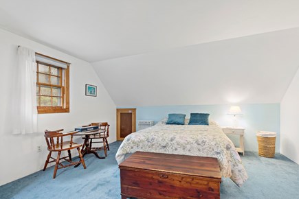Eastham Cape Cod vacation rental - Upstairs bedroom with a queen bed and table by the window