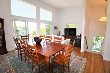 Eastham Cape Cod vacation rental - Dining space and TV area, 2 balconies to left