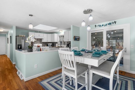 Harwich Cape Cod vacation rental - Dining area with view of the kitchen and enclosed porch